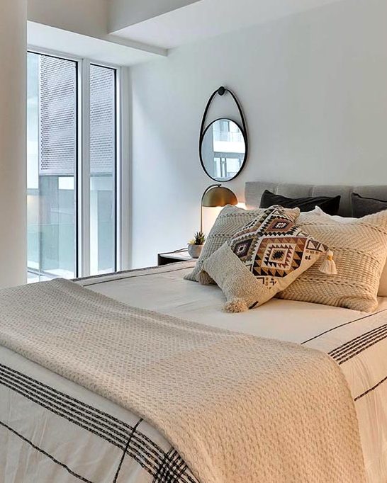 A bed made up in heavy linen, photographed close